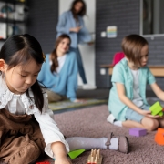 Professional cleaner disinfecting play area surfaces at a Melbourne childcare centre